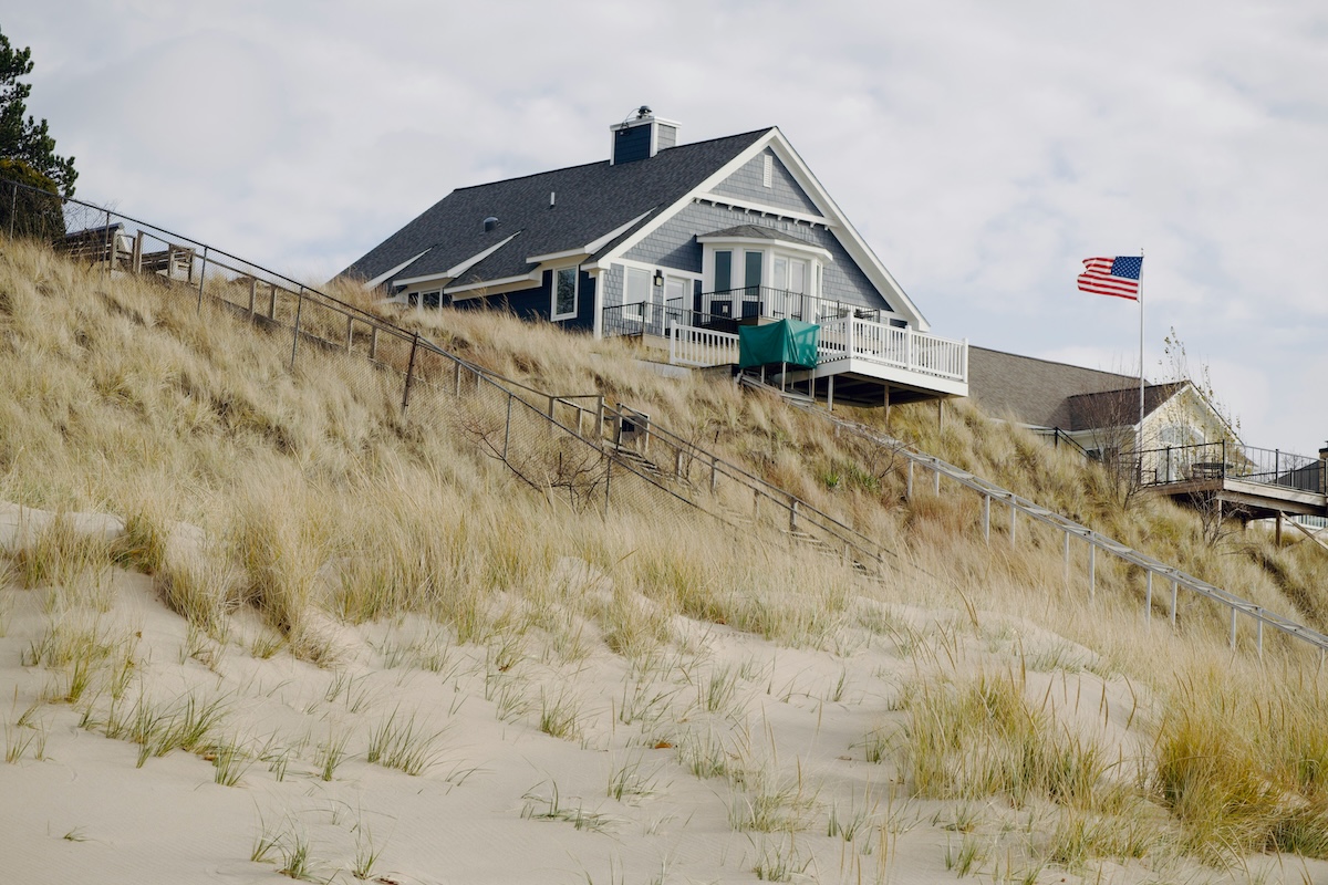 Lake Michigan dune home overlooking sandy shoreline and native grasses