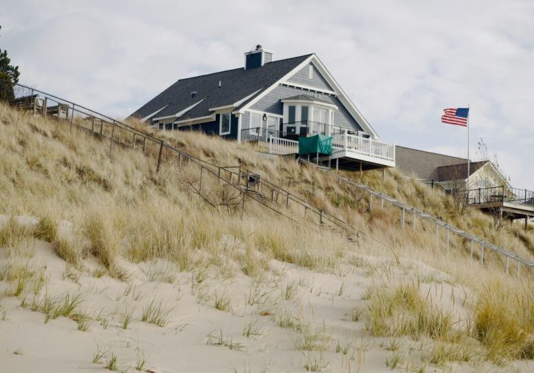 Lake Michigan dune home overlooking sandy shoreline and native grasses